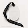 White Eternum Cherry Tobacco perfumed ceramic with embossed Thompson Ferrier logo and black branded ribbon.