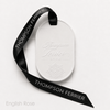 White Eternum English Rose perfumed ceramic with embossed Thompson Ferrier logo and black branded ribbon.