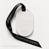 White Eternum French Gardenia perfumed ceramic with embossed Thompson Ferrier logo and black branded ribbon.
