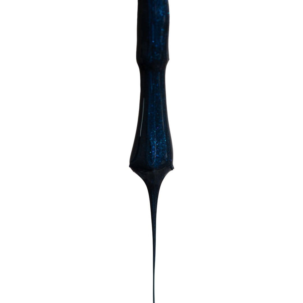 dark-blue-nail-polish-dripping-from-brush